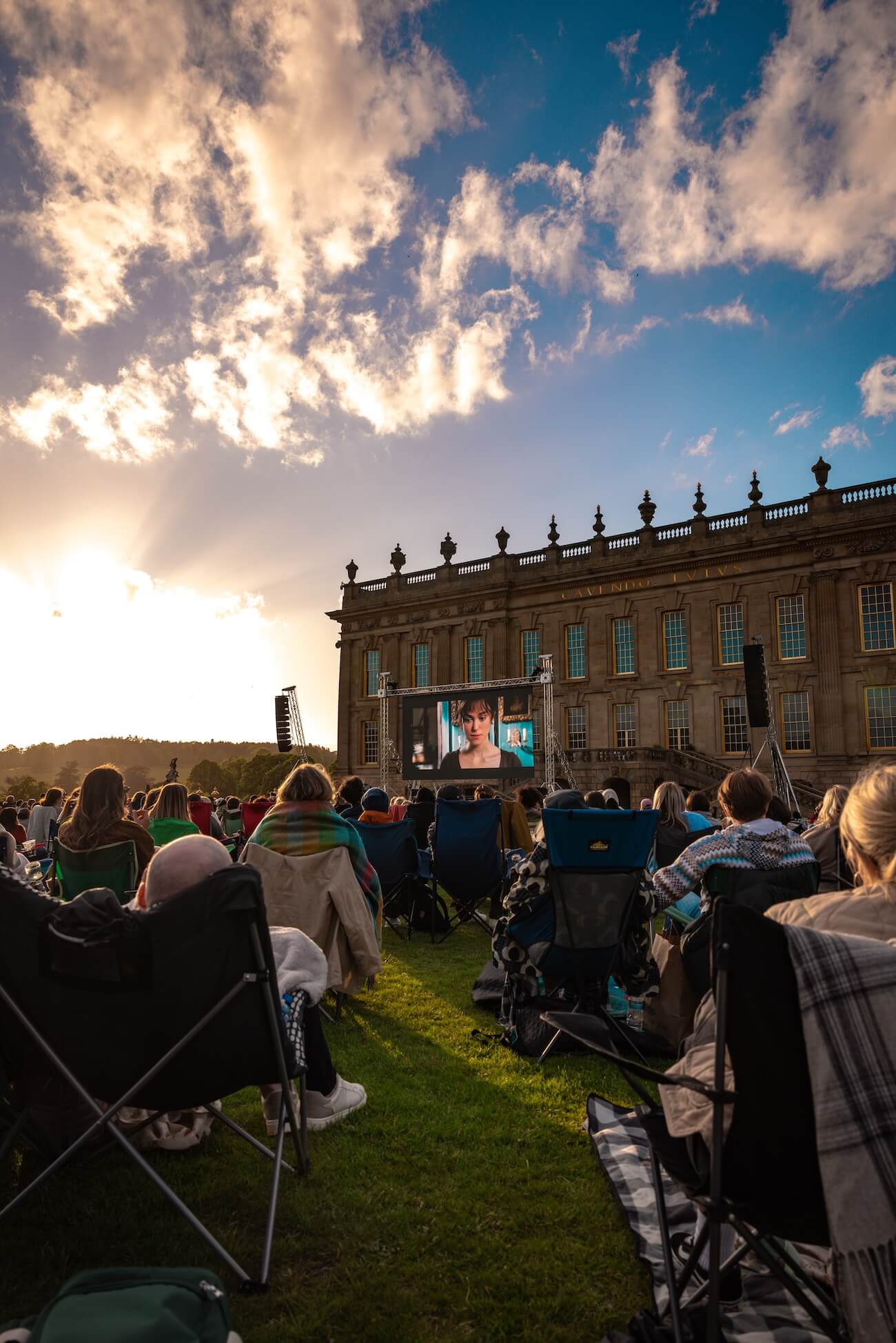 Sunset at Chatsworth House lawn with an outdoor cinema showing Pride and Prejudice